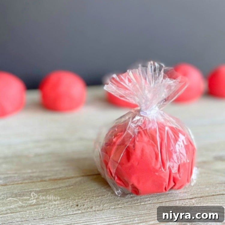 Brightly colored homemade play-doh made with Kool-Aid, showcasing a stack of different colors.