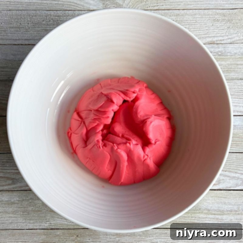 Kneading homemade playdough until it becomes soft and smooth.