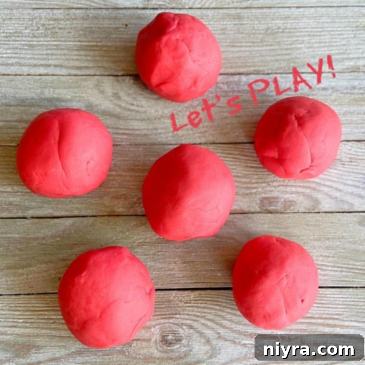 Child's hands playing with colorful homemade playdough.