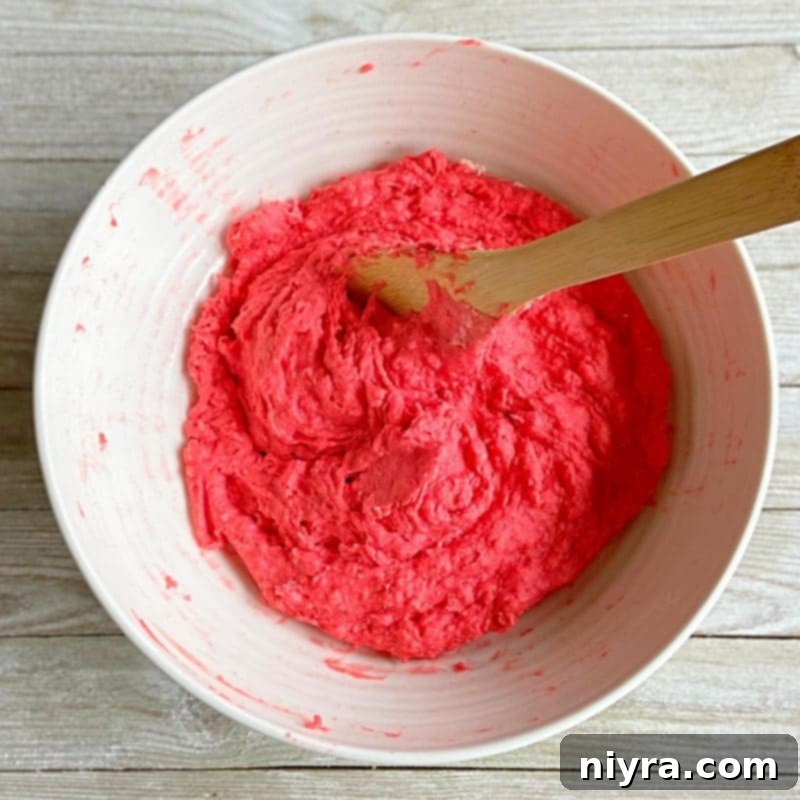 Stirring the ingredients together to form playdough.