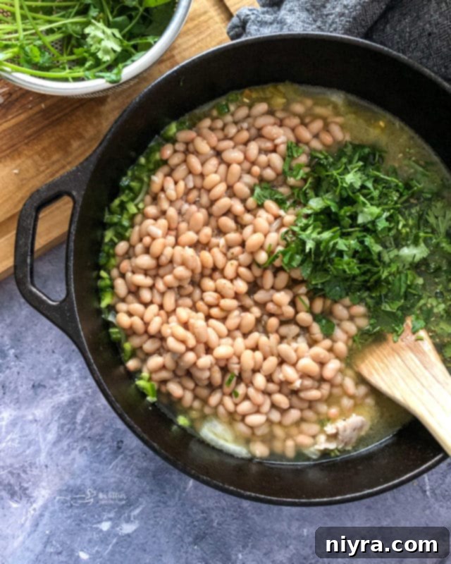 Chopped onions and garlic sautéing in olive oil in a Dutch oven.