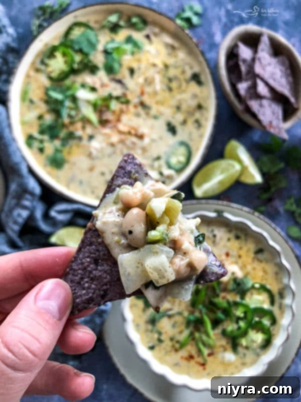 A slow cooker filled with creamy White Chicken Chili, ready to serve.
