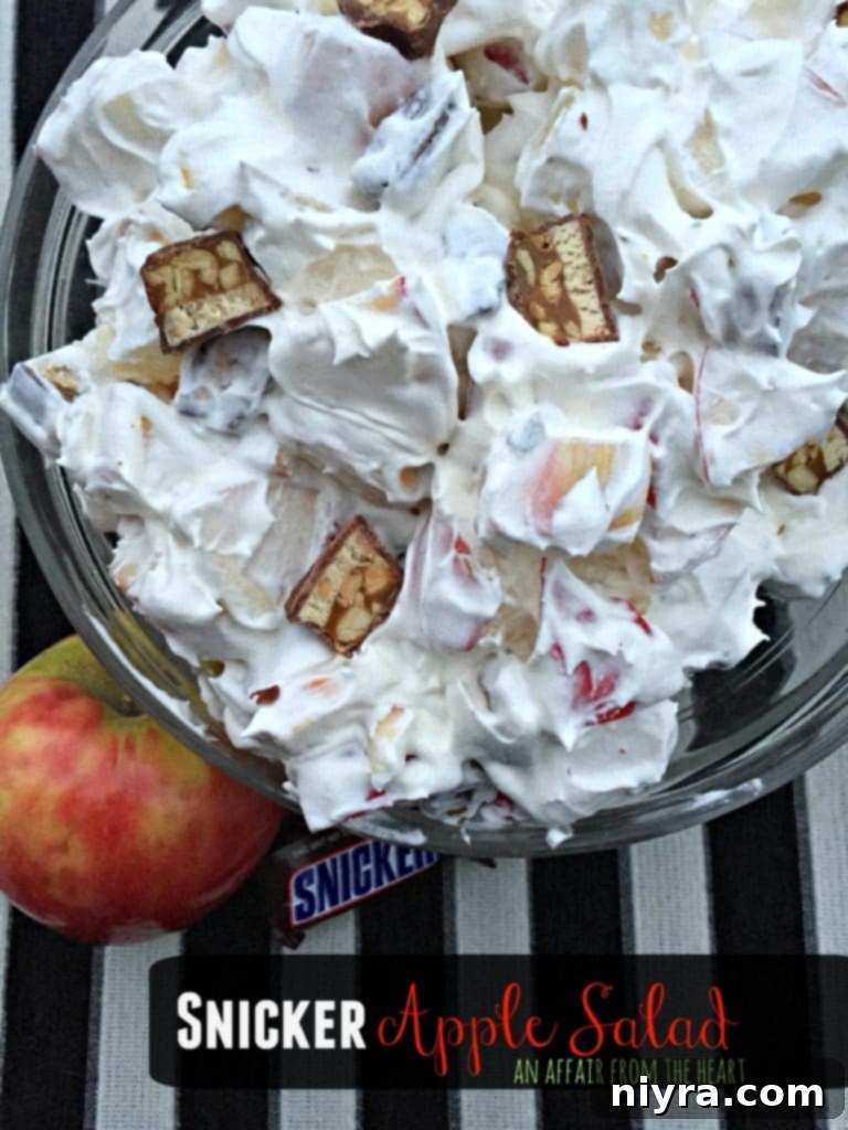 Close up shot of Snicker Apple Salad in a glass bowl, ready to serve.