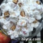 Close up of snicker apple salad in a clear bowl