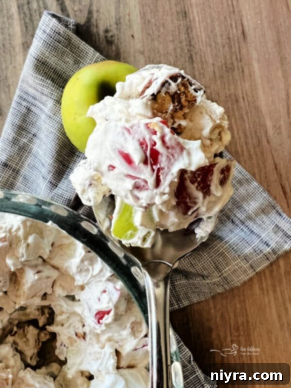 Close-up of a bowl containing chopped Snickers candy bars, ready to be added to the salad.