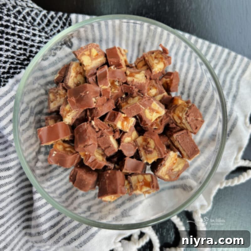Image demonstrating the second step: chopped Snickers bars.