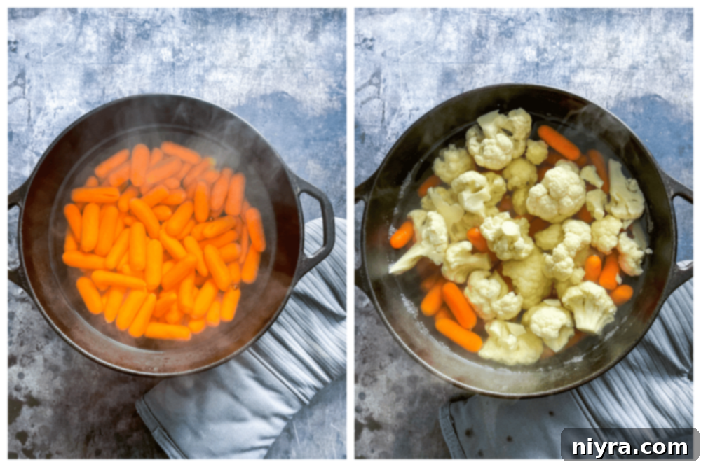 Step one: Boiling carrots and cauliflower florets in a pot of water.