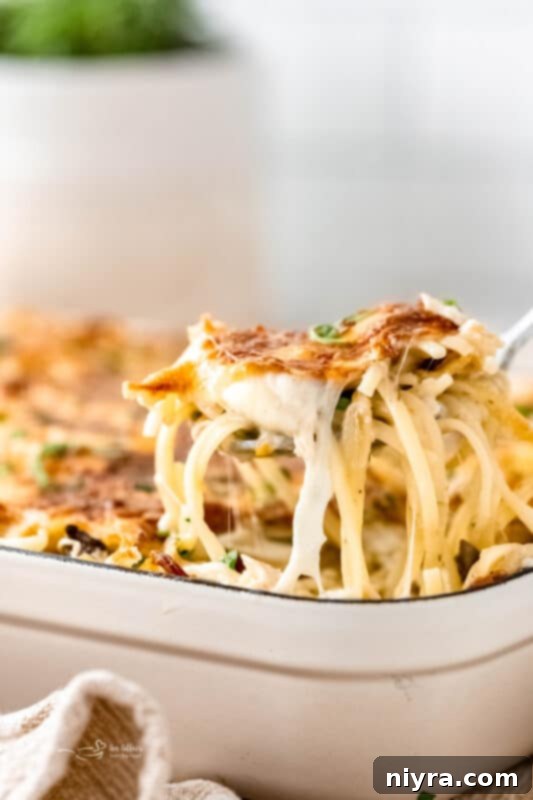 A golden-brown Turkey Pasta Bake in a casserole dish, ready to be served.