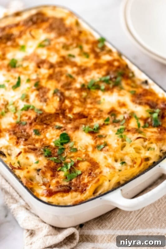 A turkey pasta bake topped with mozzarella cheese, ready to be baked.