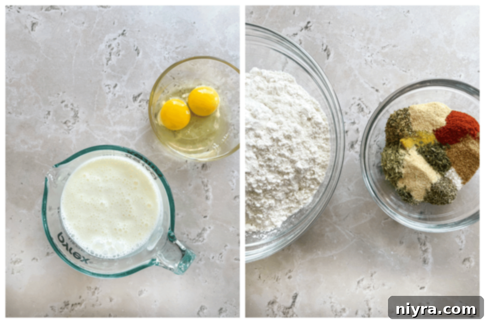 Various chicken pieces arranged on a wooden board with fresh herbs, ready for frying.