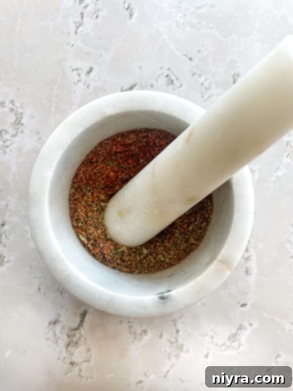 Chicken pieces soaking in a buttermilk and egg marinade in a large bowl.