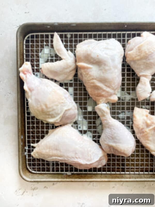 A collection of dried spices being ground in a mortar and pestle for the chicken breading.