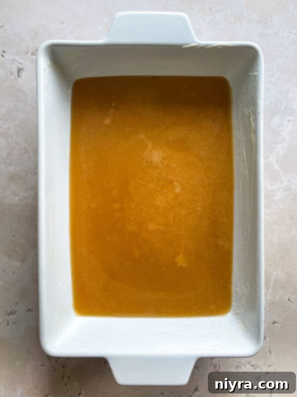 Vanilla extract being stirred into cooked caramel.