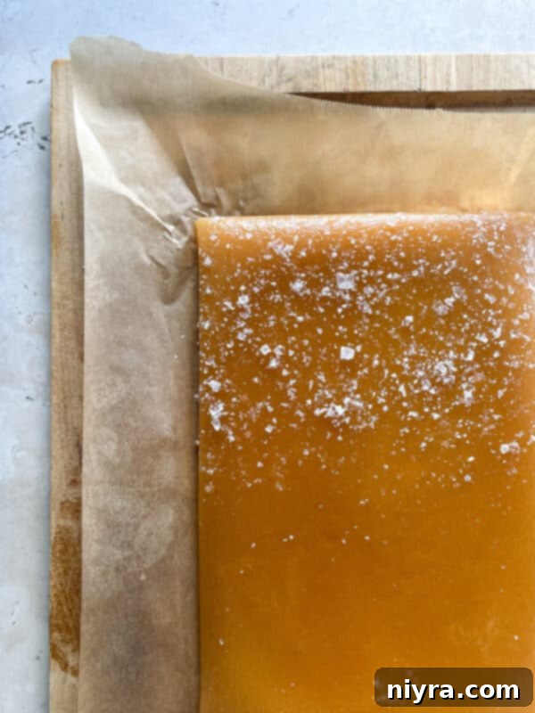 Warm caramel poured into a prepared baking dish.