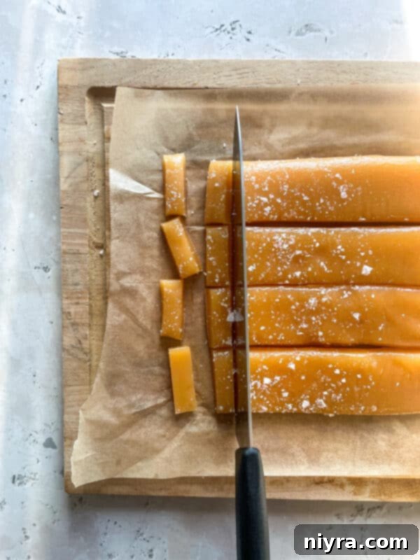 Flaky sea salt sprinkled over warm caramel in a baking dish.