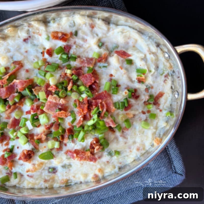 Savory Sauerkraut, Bacon and Swiss Dip 11 A baking dish with Sauerkraut Bacon Swiss Dip and various crackers and breads.