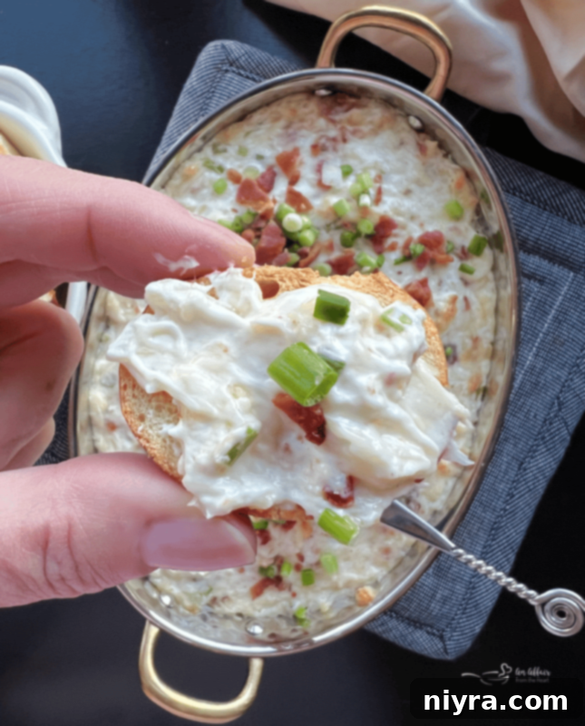 Savory Sauerkraut, Bacon and Swiss Dip 12 A close-up of the dip with a spoon.