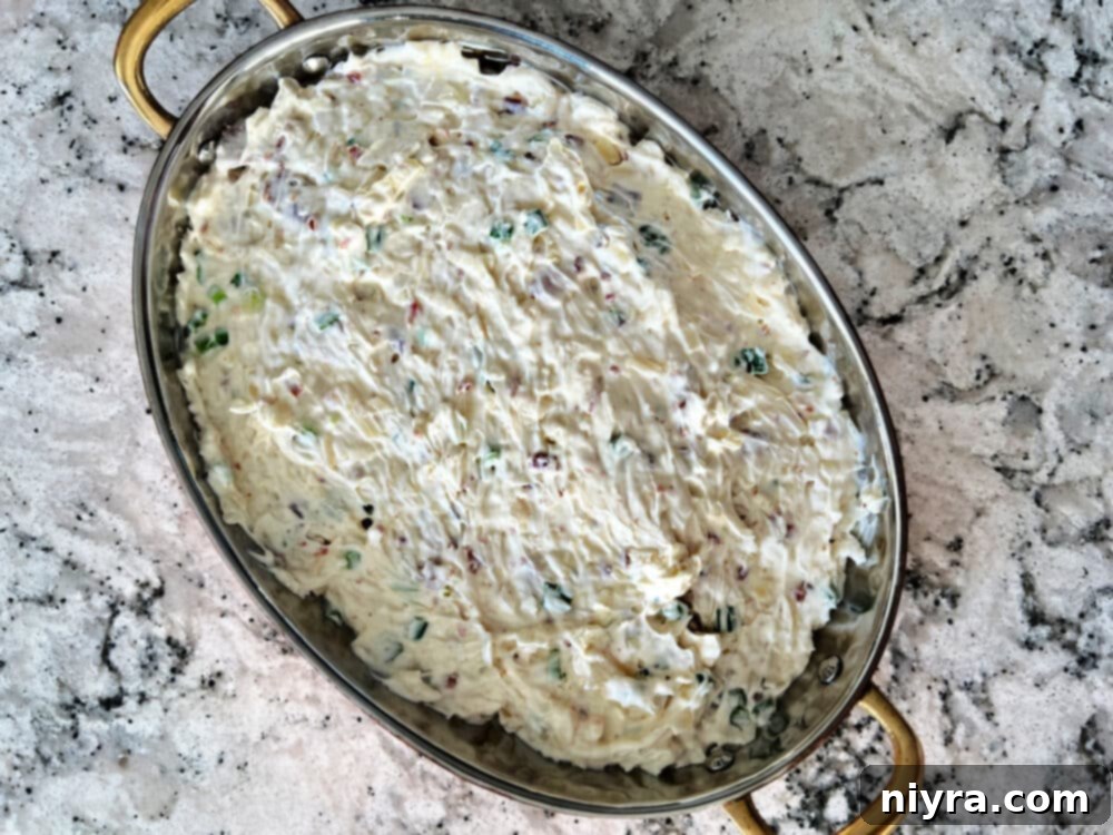 Savory Sauerkraut, Bacon and Swiss Dip 7 Step-by-step image of combining ingredients for the dip.