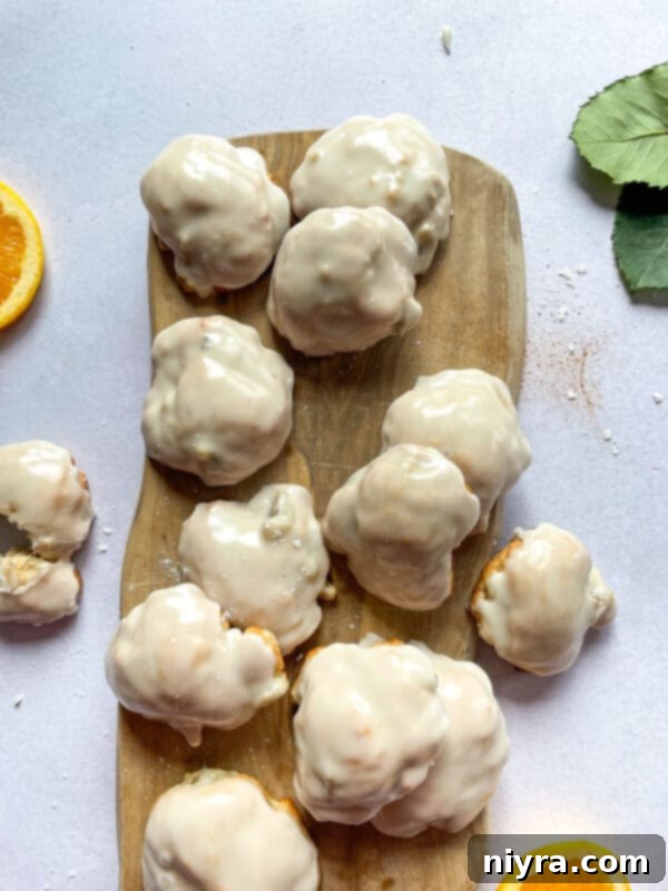 Warm Banana Bliss Bites 16 Baked banana fritters on a plate with a fork.