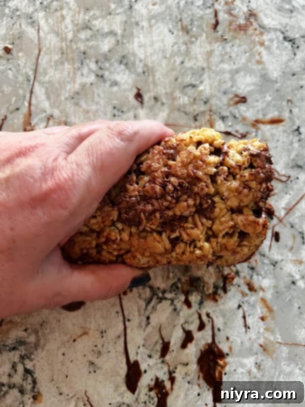 Spreading the chocolate and butterscotch topping on Scotcheroo bars.