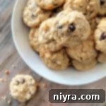 Mom's Scrumptious Cookies 19 Yum Yum Cookies stacked in a white bowl.