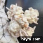 White Ting a lings stacked on a dark surface.