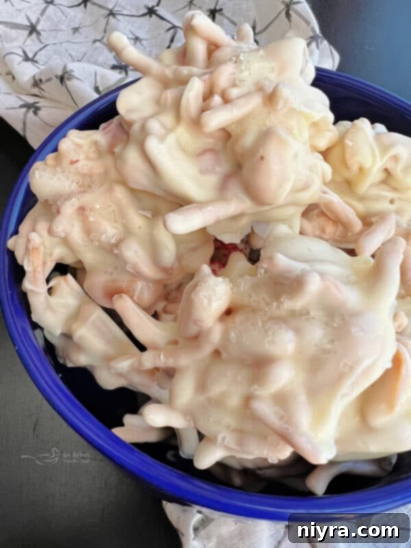 Individual White Ting A Lings being dropped onto a parchment-lined cookie sheet.