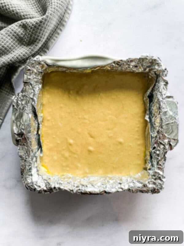 Sugar and milk mixture boiling in a saucepan on the stovetop