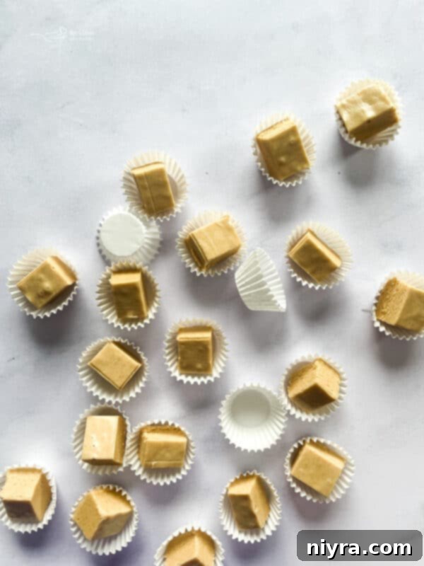 A large pile of peanut butter fudge squares on a serving plate