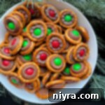 Close up of Rolo pretzels stacked in a white serving bowl.