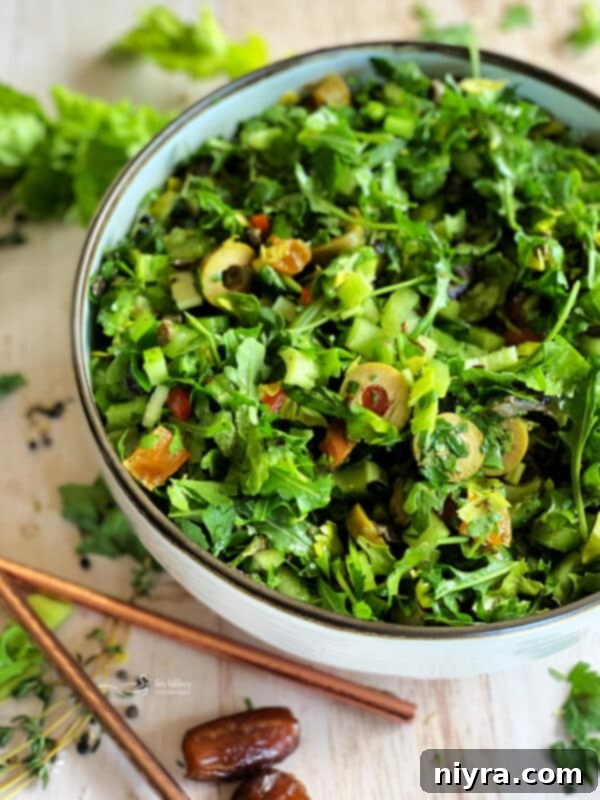 Bright Mediterranean Celery Olive Salad 2 A vibrant Mediterranean Celery Salad with Olives, featuring crisp arugula, celery, olives, apricots, and dates, tossed in a lemon herb dressing.