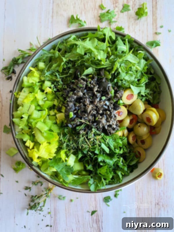 Bright Mediterranean Celery Olive Salad 8 Step 1: Whisking the lemon herb dressing ingredients in a small bowl.