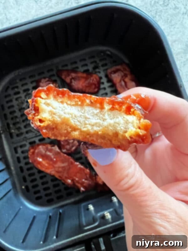 Air Fryer Quick Guide Free Printable 5 Delicious air-fried BBQ chicken tenders in a serving bowl.