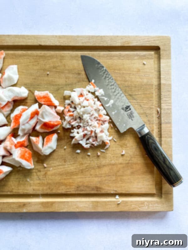 Kitchen scene showing a baking dish ready to be filled with Crab Rangoon Dip.