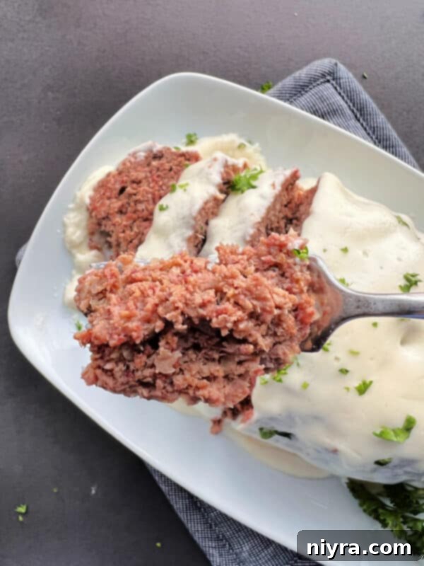 Reuben Meatloaf served on a plate with side dishes