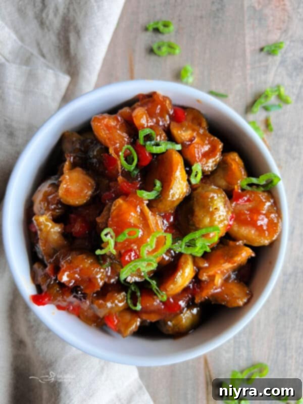 Sweet and Sour Brussels Sprouts in a bowl, garnished with green onions