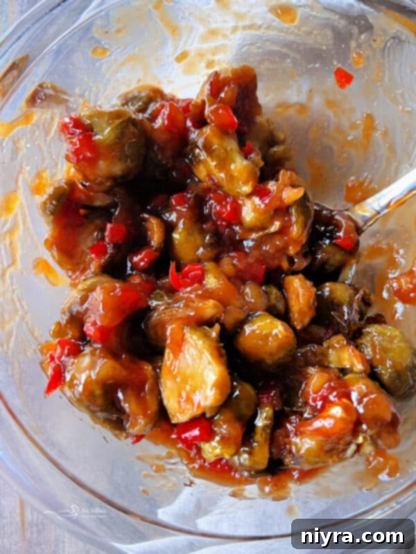 Sweet and sour Brussels sprouts being tossed in sauce