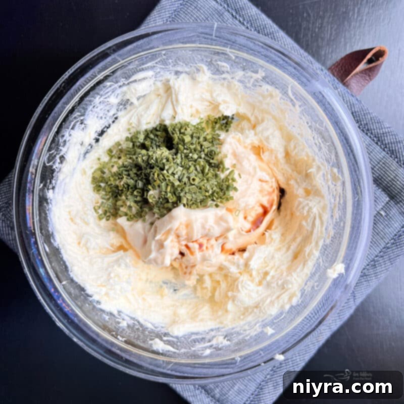 Savory Chicken Cracker Dip 5 Cream cheese being beaten smooth in a mixing bowl.