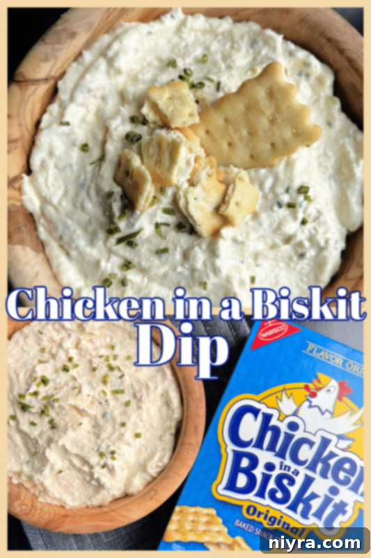 Savory Chicken Cracker Dip 7 Finished Chicken in a Biskit Dip served with crackers on a wooden board.