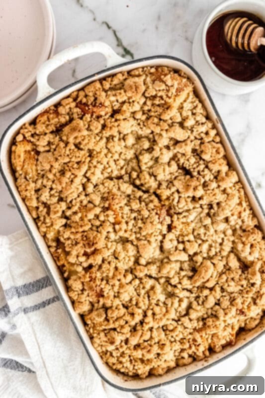 Crumb-Topped French Toast Casserole 14 Two slices of Baked French Toast Casserole on a plate with berries