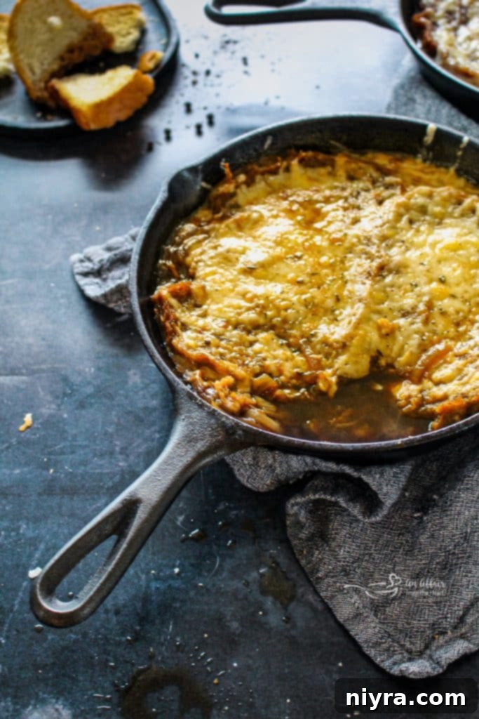 A top-down view of French Onion Soup in a white bowl