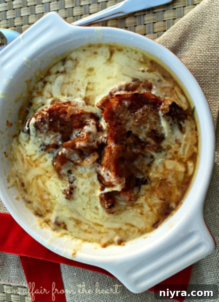 French onion soup with cheese bubbling in small cast iron skillets