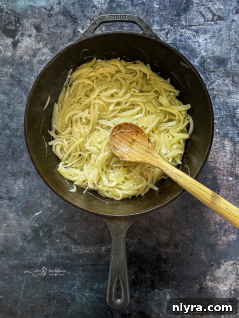 Sliced onions being caramelized in a pot
