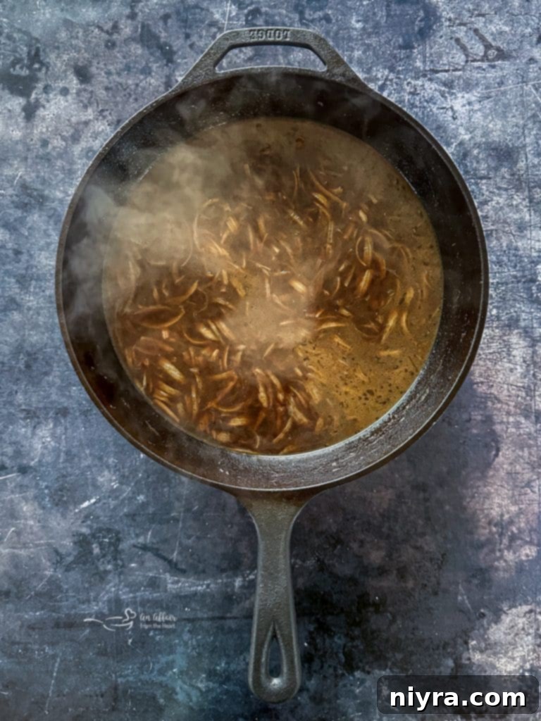 Ingredients for French Onion Soup being added to the pot