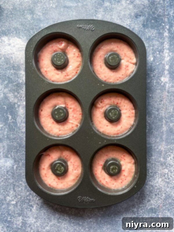 Donut batter being mixed in a bowl.