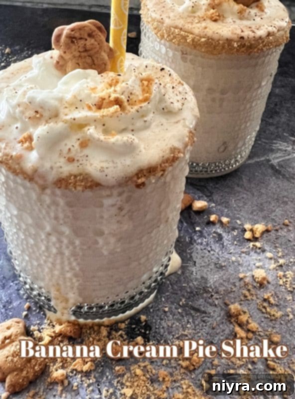 Hero shot of a perfectly garnished Banana Cream Pie Shake, ready to be enjoyed.