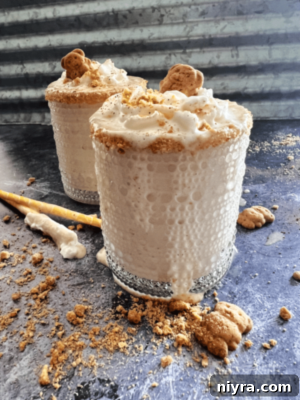 Another view of the creamy Banana Cream Pie Shake with whipped cream and graham cracker crumbs, served in a glass.