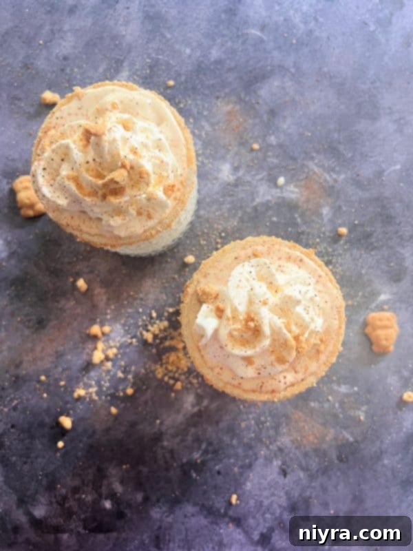 Step-by-step image of topping Banana Cream Pie Shake with whipped cream and a sprinkle of graham cracker crumbs.