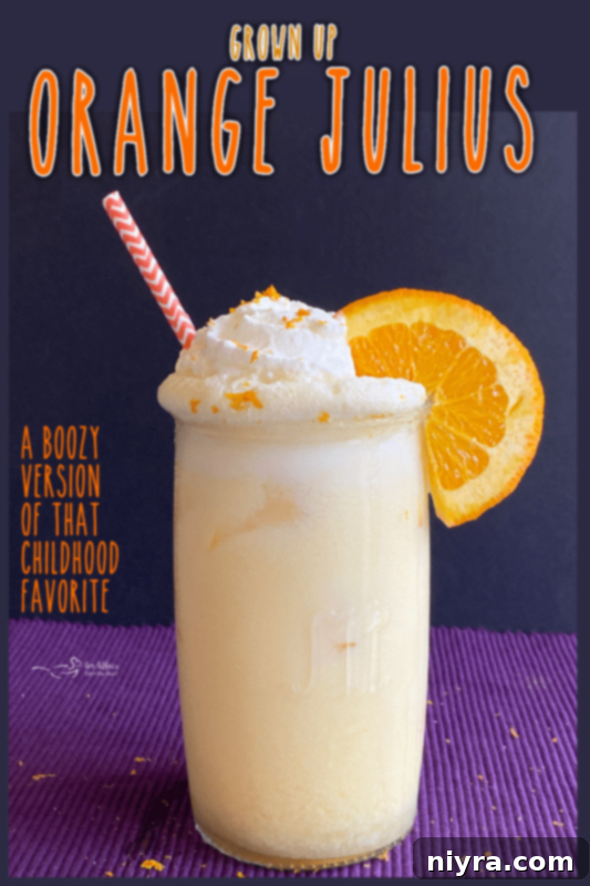 A refreshing Grown-Up Orange Julius cocktail on a vibrant background, ready to be enjoyed.