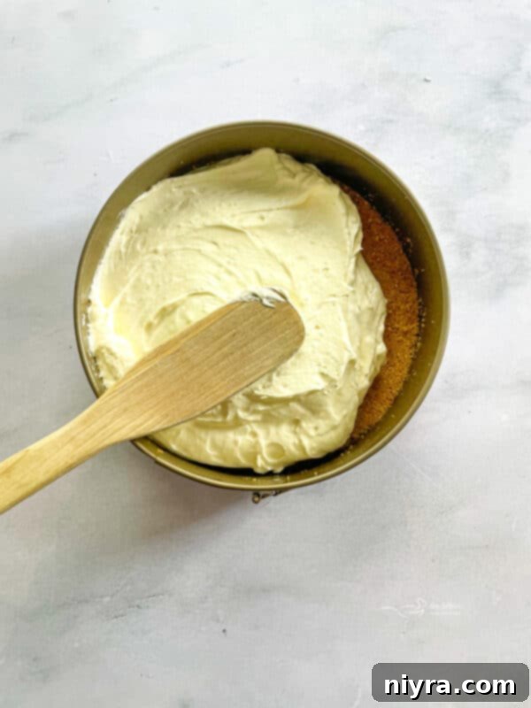 Gently folding whipped cream into the marshmallow cream cheese mixture.